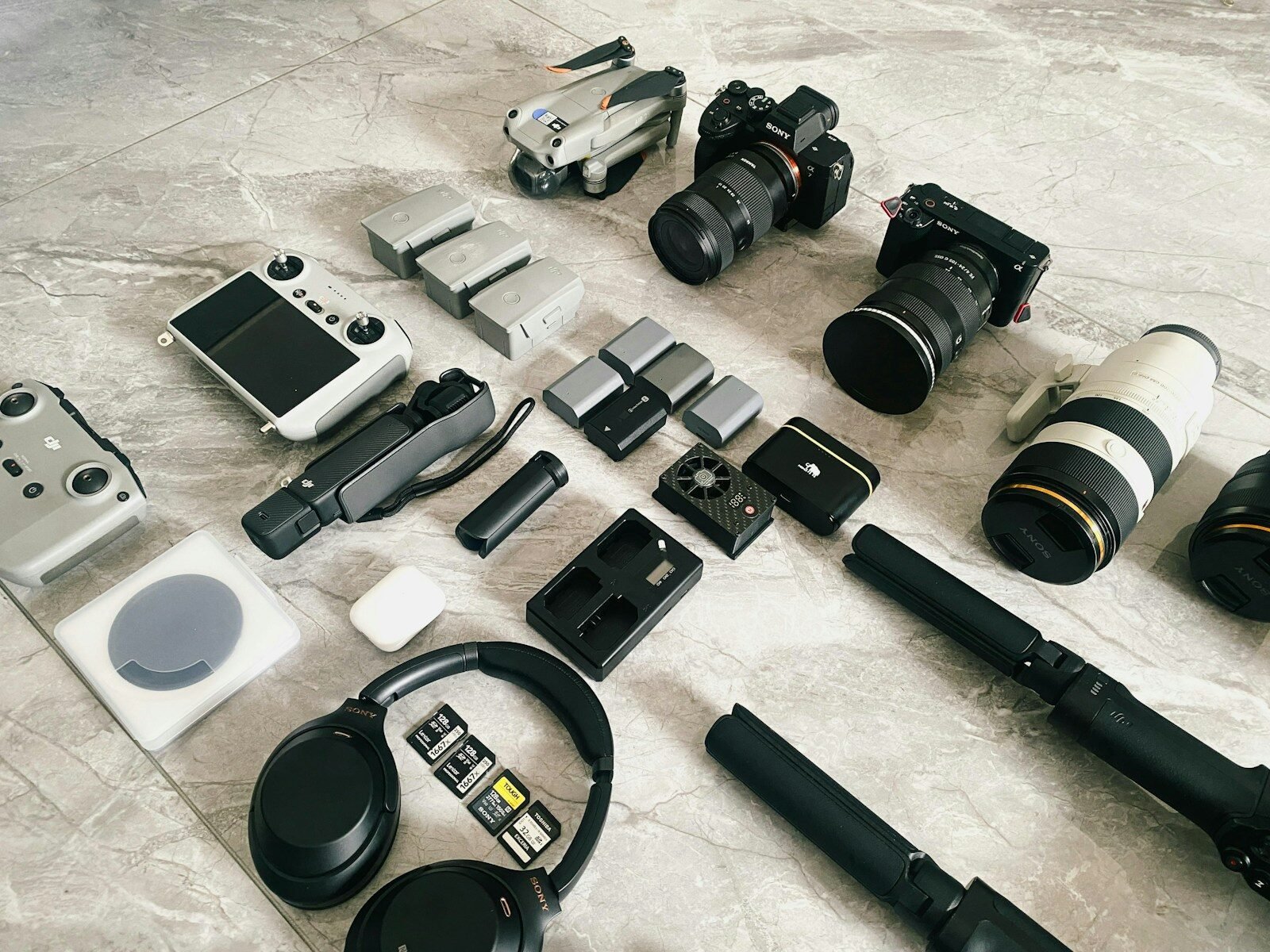 Various electronic gadgets and camera accessories laid out